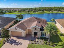 Aerial view of a house near a lake, showcasing desirable waterfront property at 678 Irvine Ranch Rd, Kissimmee, FL 34759