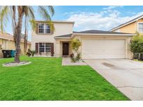 Two-story house with a two-car garage and well-maintained lawn at 4758 Wyresdale St, Orlando, FL 32808