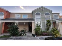 Front view of a townhome with landscaping at 2440 Summerfield Way, Kissimmee, FL 34741