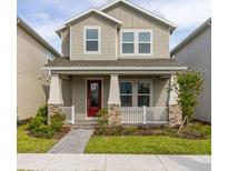 Two-story home with front porch and landscaping at 16294 Honey Harvest St, Winter Garden, FL 34787