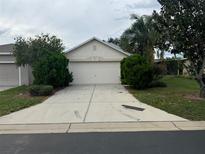 House exterior with a two-car garage and driveway at 2796 Whispering Trails Dr, Winter Haven, FL 33884