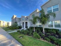 Modern two-story townhome with landscaping at 4295 Paragraph Dr, Kissimmee, FL 34746