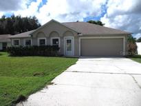 Single-story home with attached garage and lawn at 1118 Perpignan Ct, Kissimmee, FL 34759