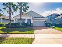 One-story home with gray siding, brick accents, and a covered porch at 3758 Prairie Reserve Blvd, Orlando, FL 32824