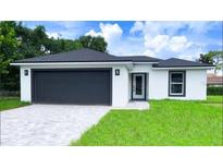 Modern house with a dark gray garage door and a light gray exterior at 57 Pine Cir, Ocala, FL 34472