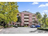 Three-story apartment building with parking and landscaping at 7650 Whisper Way # 203, Reunion, FL 34747