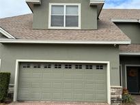 Attached garage with green door and brick pavers at 6364 Sedgeford Dr, Lakeland, FL 33811