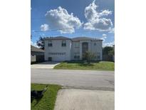 Two-story house with attached garage and front yard at 255 Abbotsbury Dr, Kissimmee, FL 34758