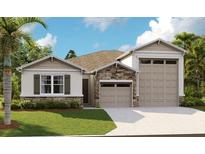 Modern home with stone accents and two-car garage at 4072 Bannock Ave, Tavares, FL 32778