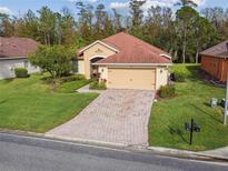 One-story home with a brick driveway at 540 Genoa Dr, Poinciana, FL 34759