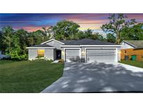 Newly constructed home with a two-car garage and well-manicured lawn at 792 Del Prado Dr, Kissimmee, FL 34758