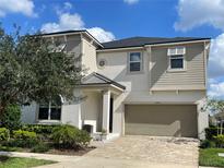 Two-story house with a large driveway and landscaped yard at 1799 Caribbean View Ter, Kissimmee, FL 34747