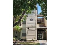 Exterior view of a light beige building with stairs at 1940 Lake Atriums Cir # 94, Orlando, FL 32839