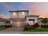 Two-story house with a two-car garage and landscaped yard at 5075 Twin Lakes Blvd, Saint Cloud, FL 34772
