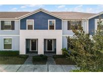 Two-story duplex with blue siding and white accents at 8912 Sydney Ave, Kissimmee, FL 34747