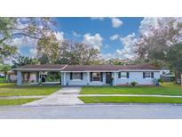 Ranch style home with carport, landscaped lawn and neutral exterior paint at 136 Alhambra Ave, Altamonte Springs, FL 32714