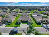 Community overview featuring multiple villas and lush landscaping at 2216 Mystic Ring Loop, Poinciana, FL 34759