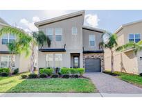 Modern two-story home with gray facade and attractive landscaping at 712 Whistling Straits Blvd, Davenport, FL 33896