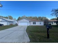 Cute one-story home with a large driveway and well-maintained lawn at 824 San Pedro Ct, Kissimmee, FL 34758