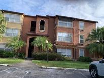 Attractive condo building with landscaping and parking at 5140 Conroy Rd # 38, Orlando, FL 32811