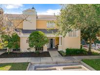 Inviting two-story townhome with a charming front porch and well-manicured landscaping at 7510 Seven Eagles Way # 7510, Reunion, FL 34747