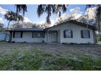 Ranch-style home with a spacious yard and mature trees at 1604 Royal Palm Dr, Edgewater, FL 32132