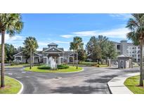 Gated entrance to community with fountain and landscaping at 3176 Feltrim Pl # 102, Kissimmee, FL 34747