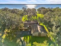 Aerial view of single-story home on waterfront property with lush landscaping at 5100 Helen Ct, St Cloud, FL 34772