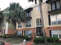 Exterior view of a two-story condo building with palm trees at 4119 Dijon Dr # 4119H, Orlando, FL 32808