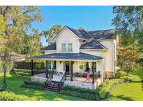 Beautiful two-story home with a wraparound porch and manicured lawn at 729 Main Street, Windermere, FL 34786