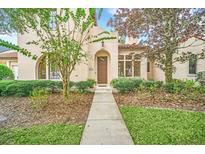 Inviting front entrance with walkway, landscaping, and classic architectural details at 1233 Aquila Loop, Celebration, FL 34747