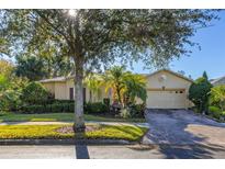 Attractive single-story home with a well-manicured lawn and paver driveway at 1287 Glendora Rd, Kissimmee, FL 34759