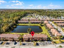 Aerial view of townhouses with lake, showcasing community and location at 2618 Bugatti Ct, Kissimmee, FL 34746