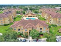 Aerial view of apartment community with pool and surrounding landscape at 504 Terrace Ridge Cir # 311, Davenport, FL 33896