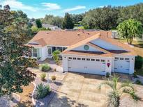 Attractive single-story home with a large driveway and landscaped yard at 2494 Five Forks Trl, The Villages, FL 32162