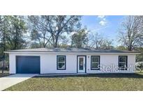 Newly constructed home with a modern exterior and attached garage at 297 Oak Lane Way, Ocala, FL 34472