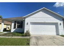 Newly constructed one-story home with a two-car garage and a well-maintained lawn at 2857 Lyndscape St, Orlando, FL 32833