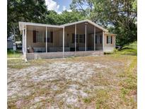 Mobile home with covered porch and large yard at 4914 Dove Ln, Auburndale, FL 33823