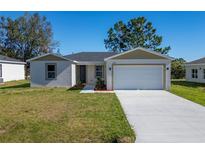 Newly built home with a two-car garage and front yard at 1603 Tench Ct, Kissimmee, FL 34759