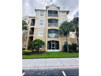 Three-story condo building with palm trees and ample parking at 2778 Almaton Loop # 303, Kissimmee, FL 34747