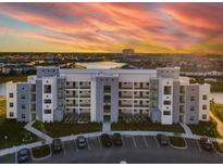Modern apartment building with lake view and parking at 4741 Clock Tower Dr # 205, Kissimmee, FL 34746
