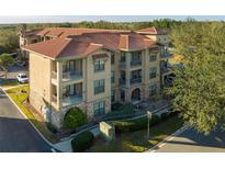 Spanish-style condo building with tile roofs and balconies at 902 Charo Pkwy # 636, Davenport, FL 33897