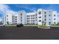 Modern condo building with ample parking and landscaped grounds at 3150 Paradox Cir # 208, Kissimmee, FL 34746