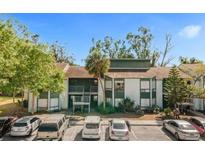Condo building with parking lot and landscaping at 2602 Lemon Tree Ln # H, Orlando, FL 32839