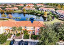 Aerial view of townhome community; property located near lake at 3083 Yellow Lantana Ln, Kissimmee, FL 34747