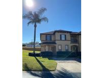 Two-story townhome with attractive landscaping and a paved driveway at 467 La Mirage St, Davenport, FL 33897