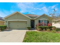 Attractive single-story house with a two-car garage and landscaped lawn at 1577 Diamond Loop, Kissimmee, FL 34744