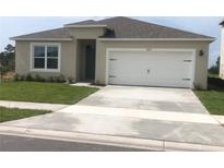 One-story house with attached garage and well-maintained lawn at 2672 Harmonia Hammock Rd, Harmony, FL 34773