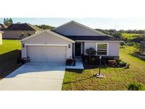 One-story house with a two-car garage and well-manicured lawn at 326 Dinner Lake Ct, Lake Wales, FL 33859