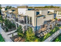 Modern townhome with gray exterior, balconies, and landscaping at 1800 Houston St, Kissimmee, FL 34743